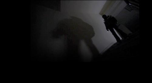 Expressionist lighting conveys suspense in the basement internet cafe