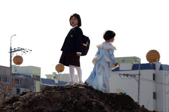 The girls await their mother atop the 'treeless mountain' The girls await their mother atop the 'treeless mountain'