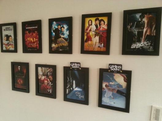 Posters of the films produced by REALIES Pictures adorn the walls