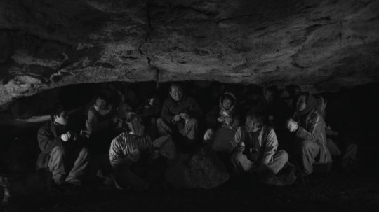 The residents of the town seek shelter and safety in a cave